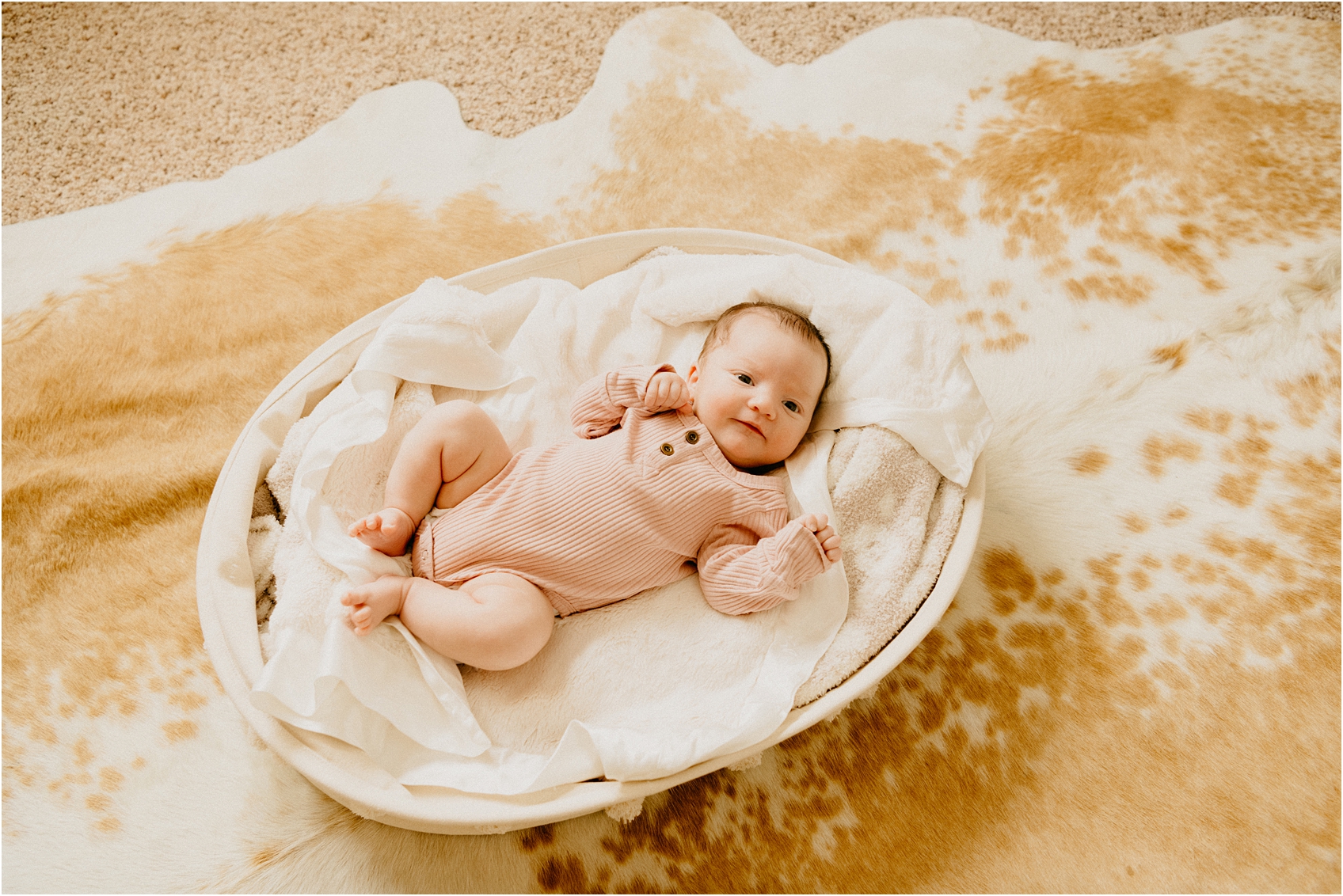 baby in a basket looking at camera
