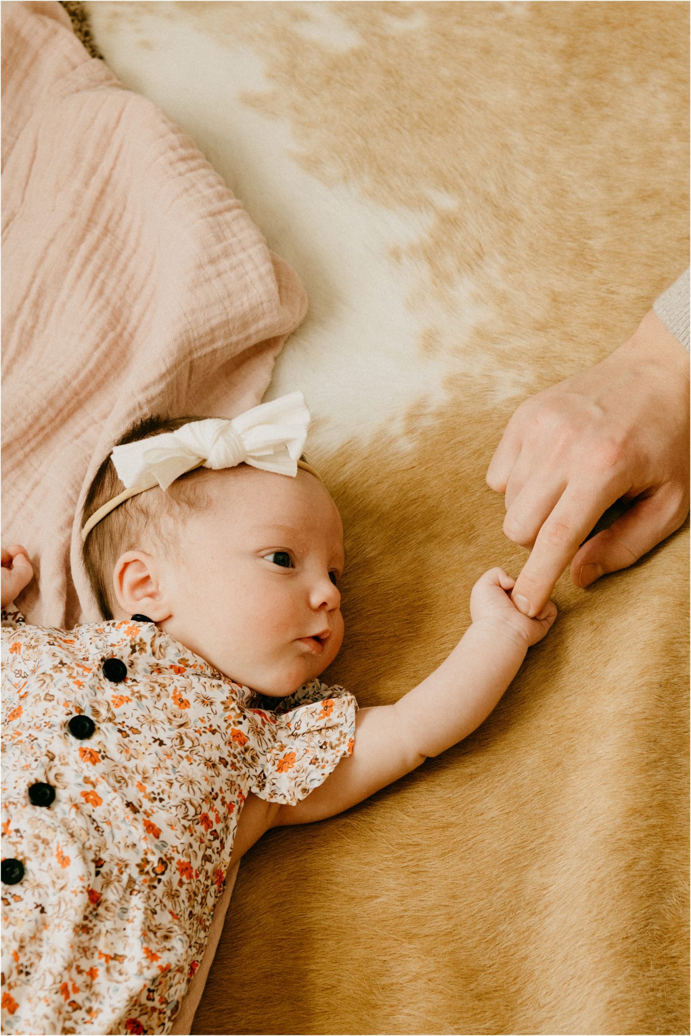 dad holding baby's finger