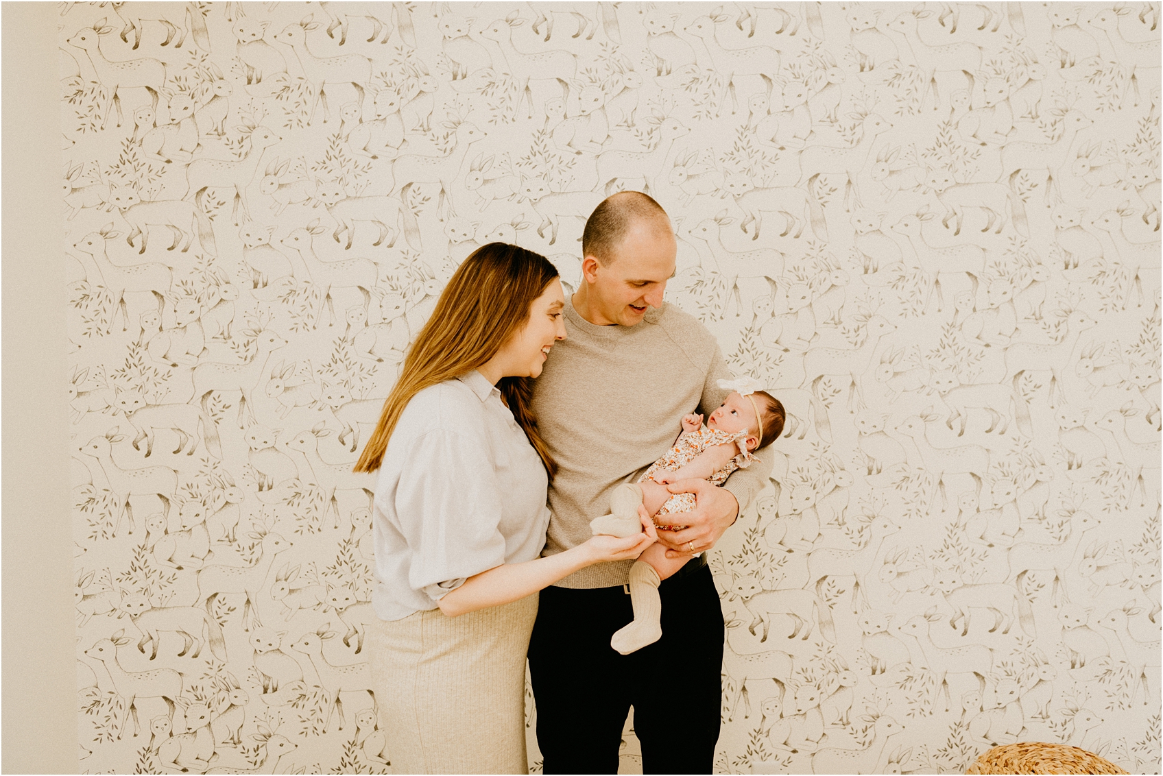 mom and dad holding baby