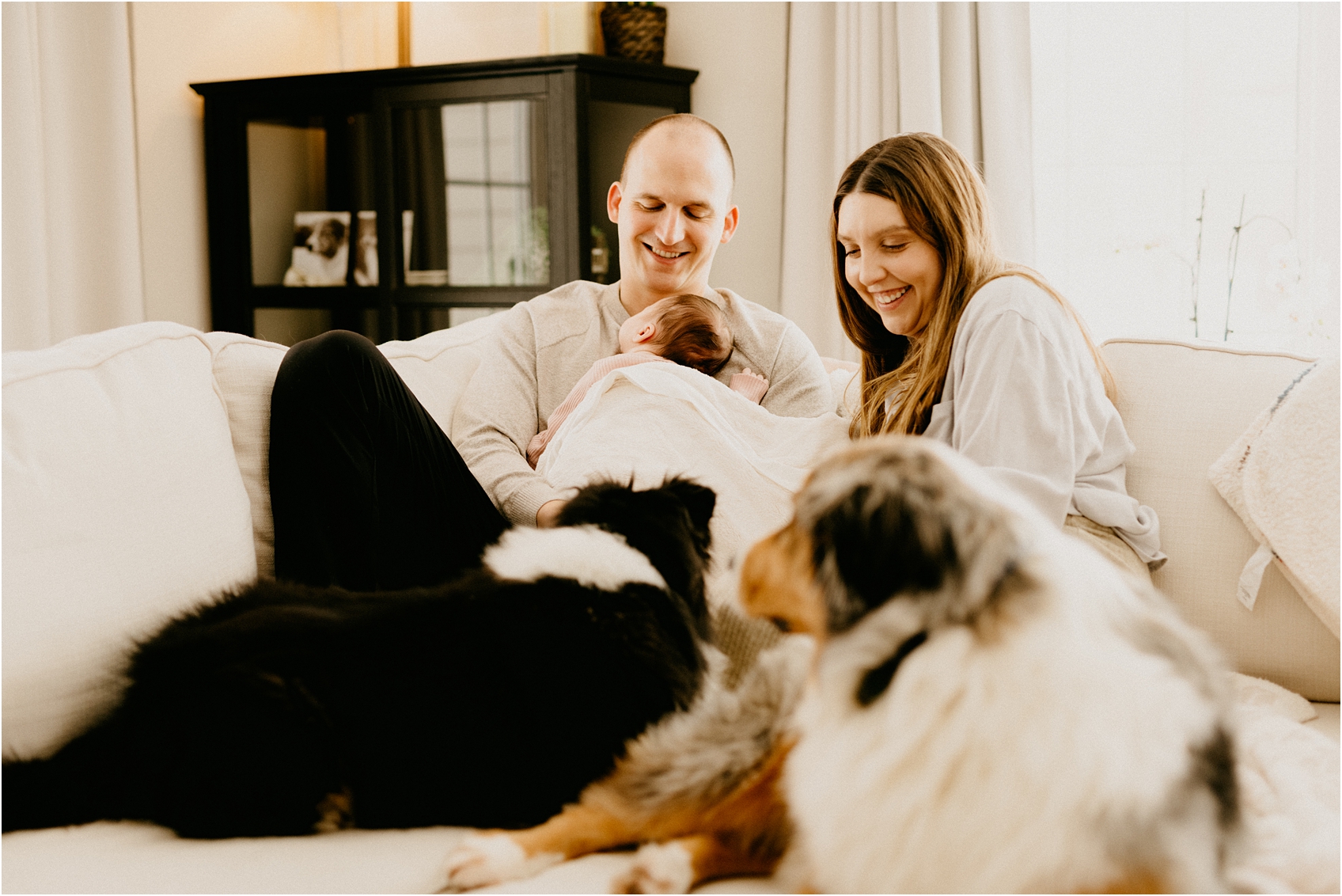 mom and dad and baby on a couch