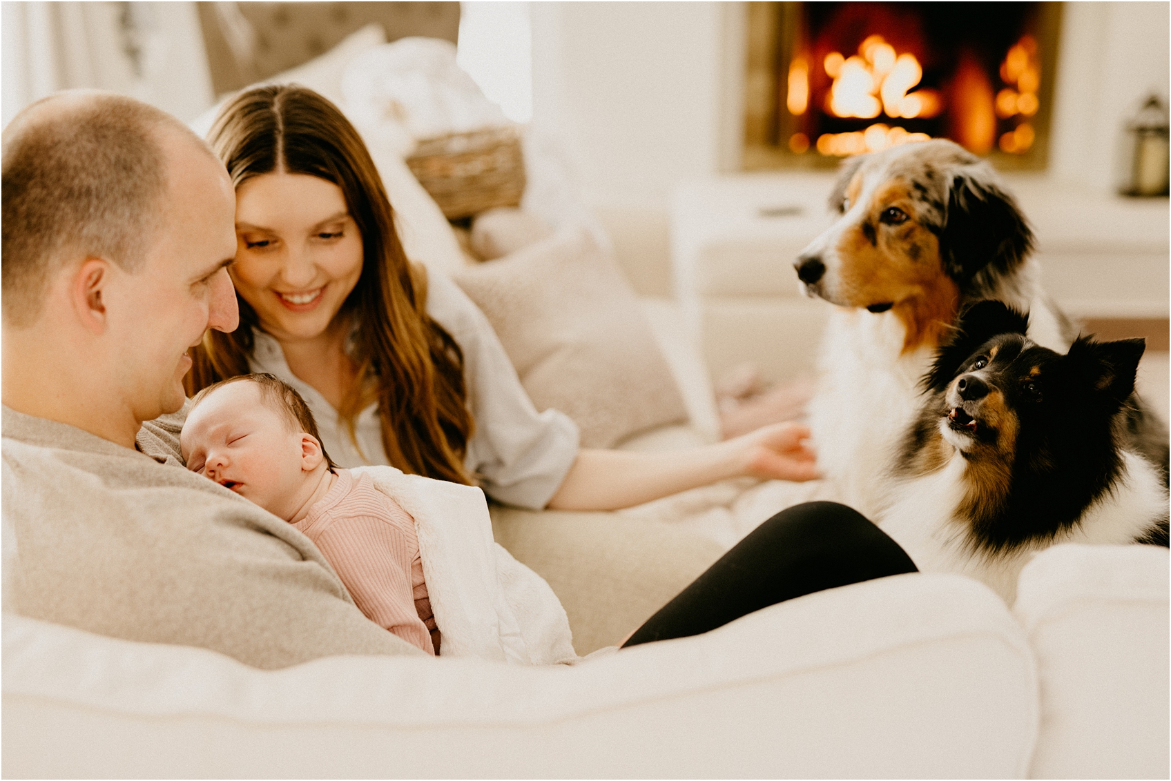 mom and dad and baby on a couch