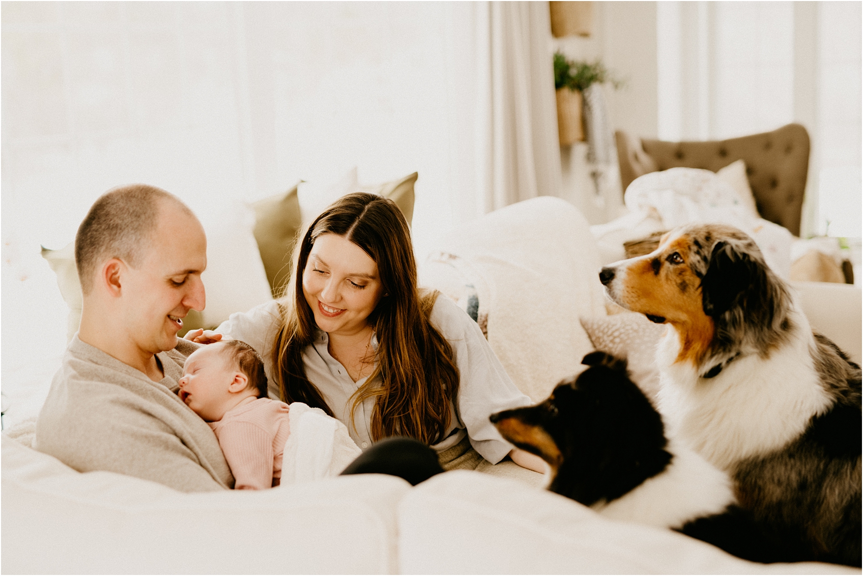 mom and dad and baby on a couch