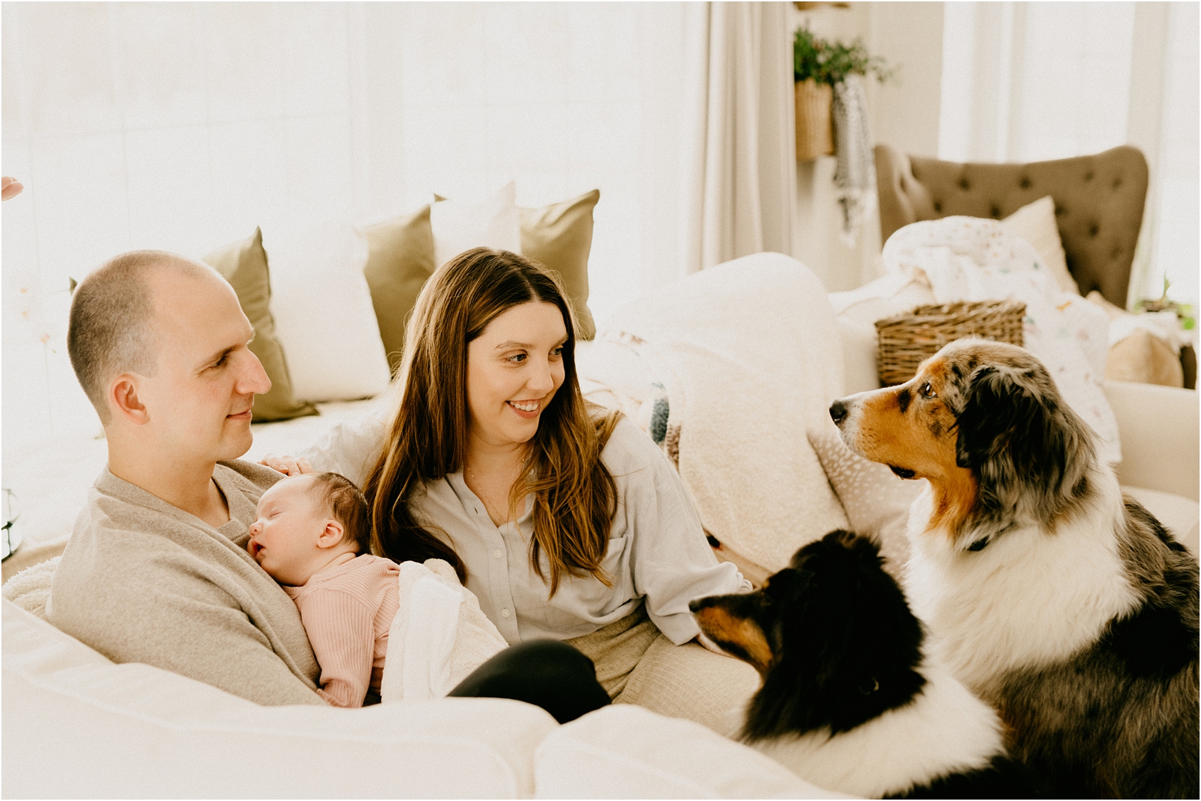 mom and dad and baby on a couch