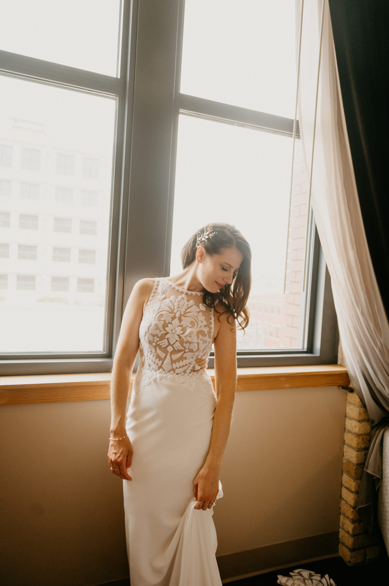 bride posing near window
