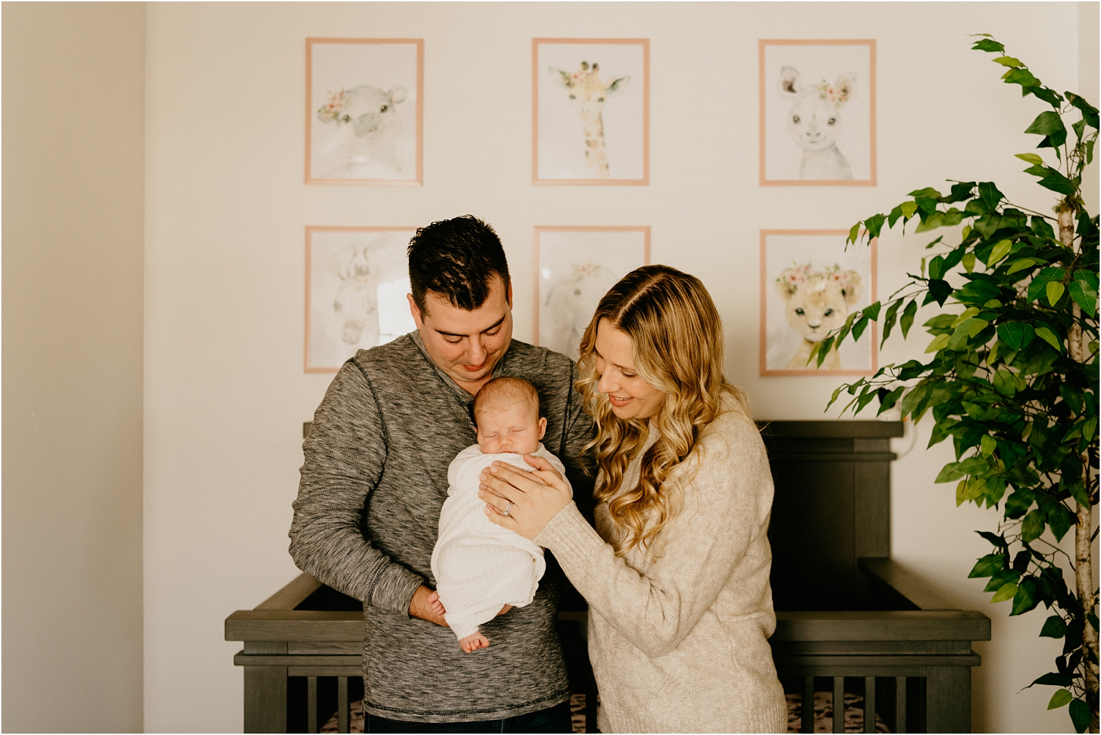 mom and dad holding baby