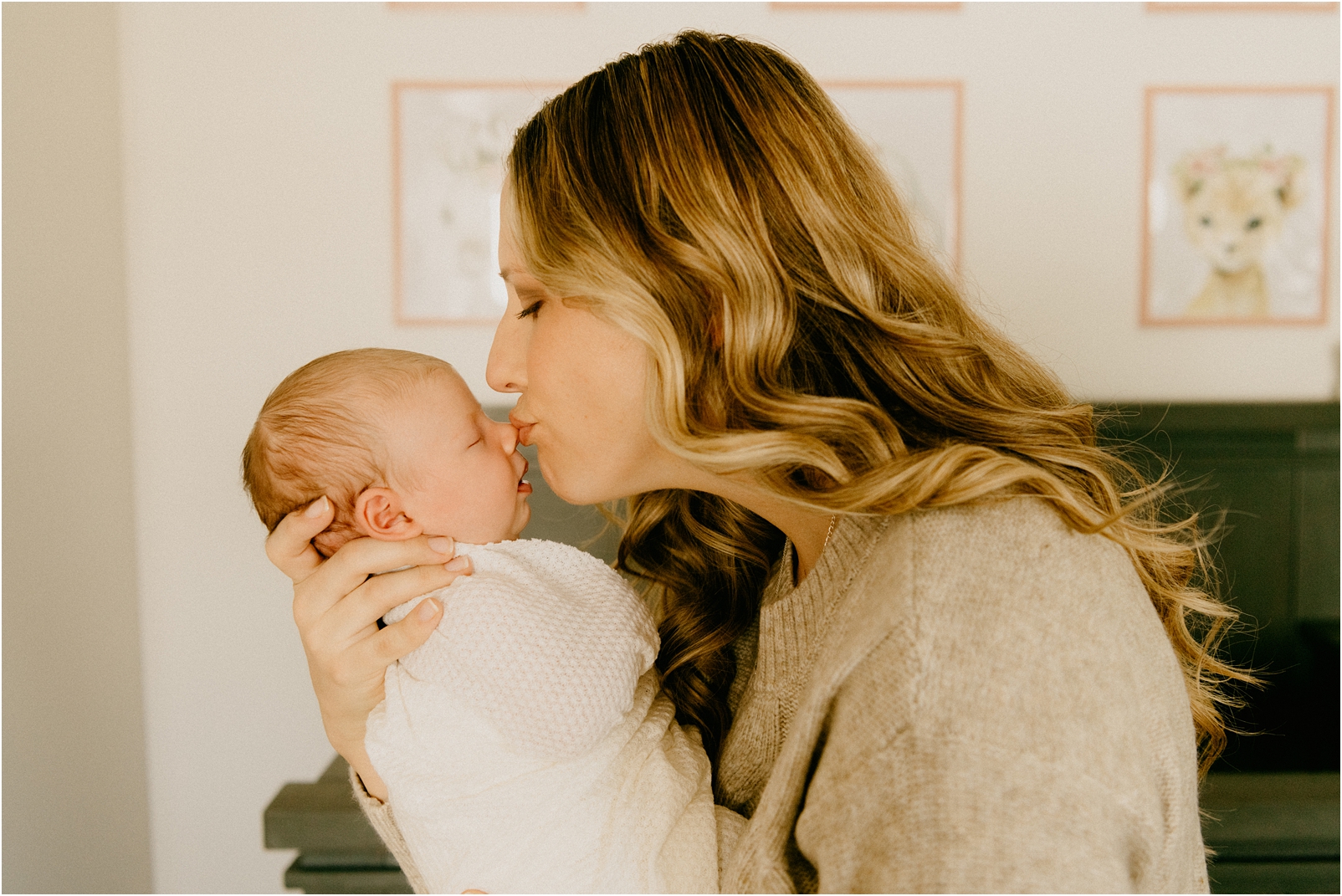 mom kissing baby