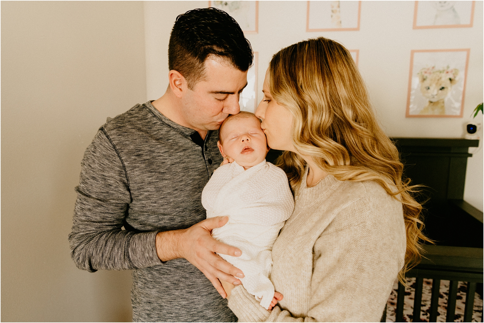 mom and dad kissing baby