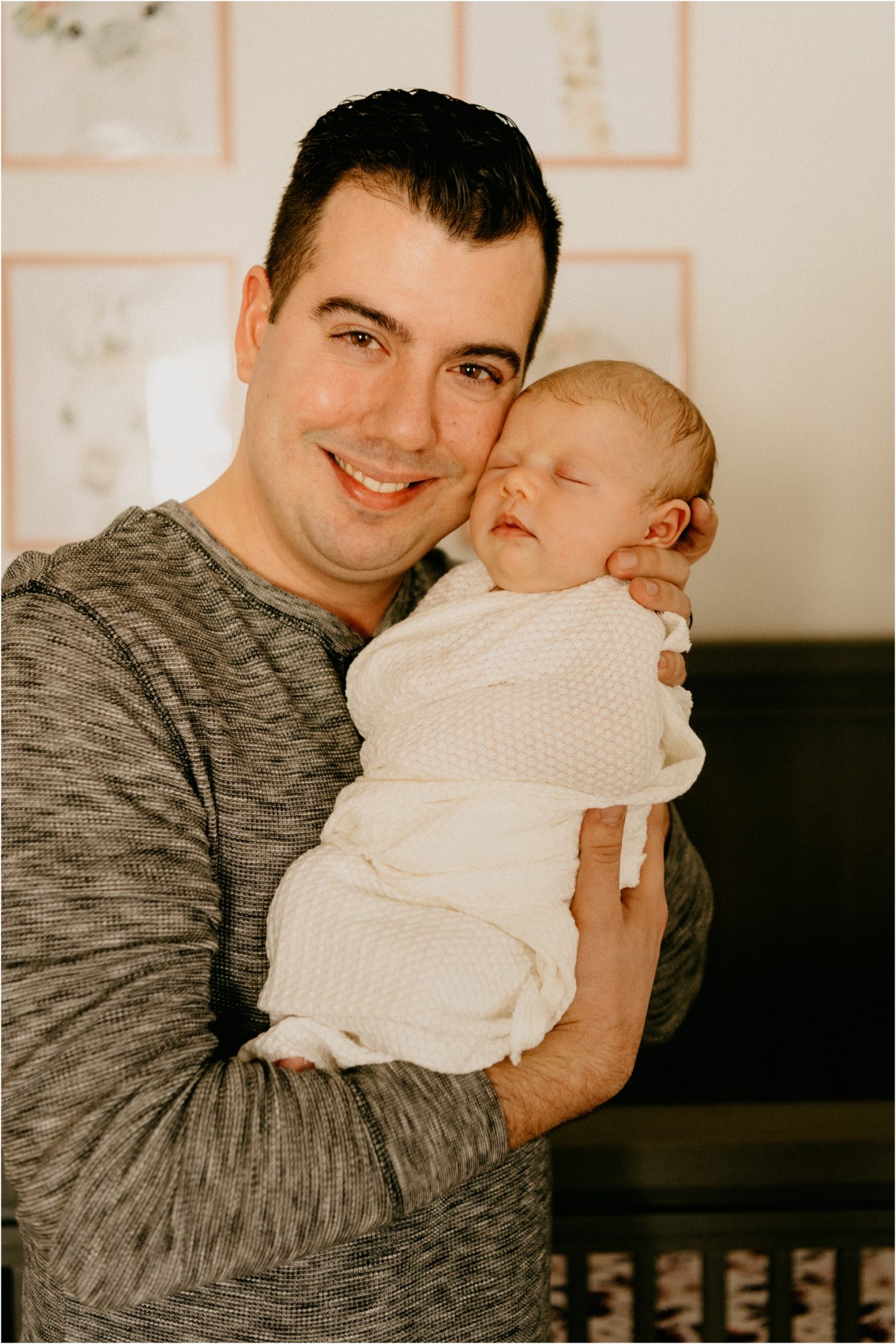 dad smiling with newborn baby