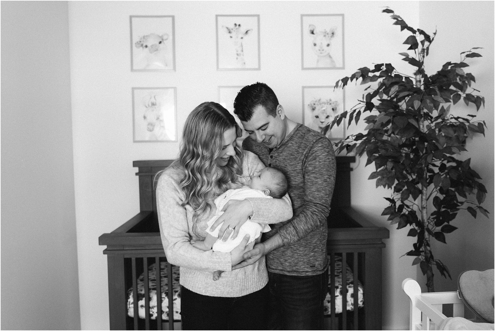 black and white photo mom and dad with baby