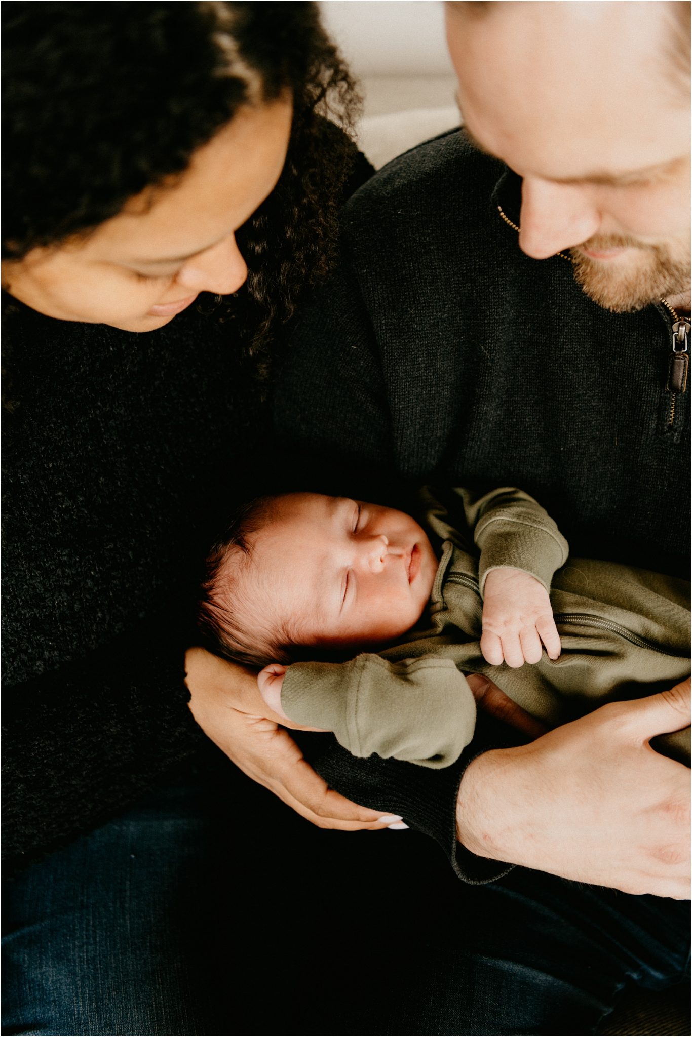 parents holding newborn baby