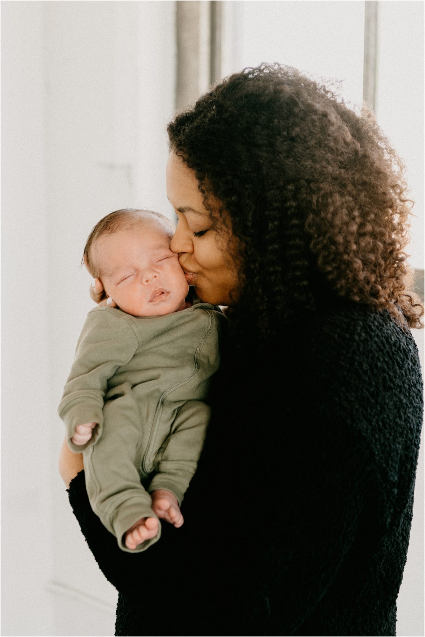 mom kissing baby