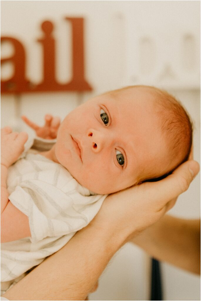 wide eyed newborn baby boy