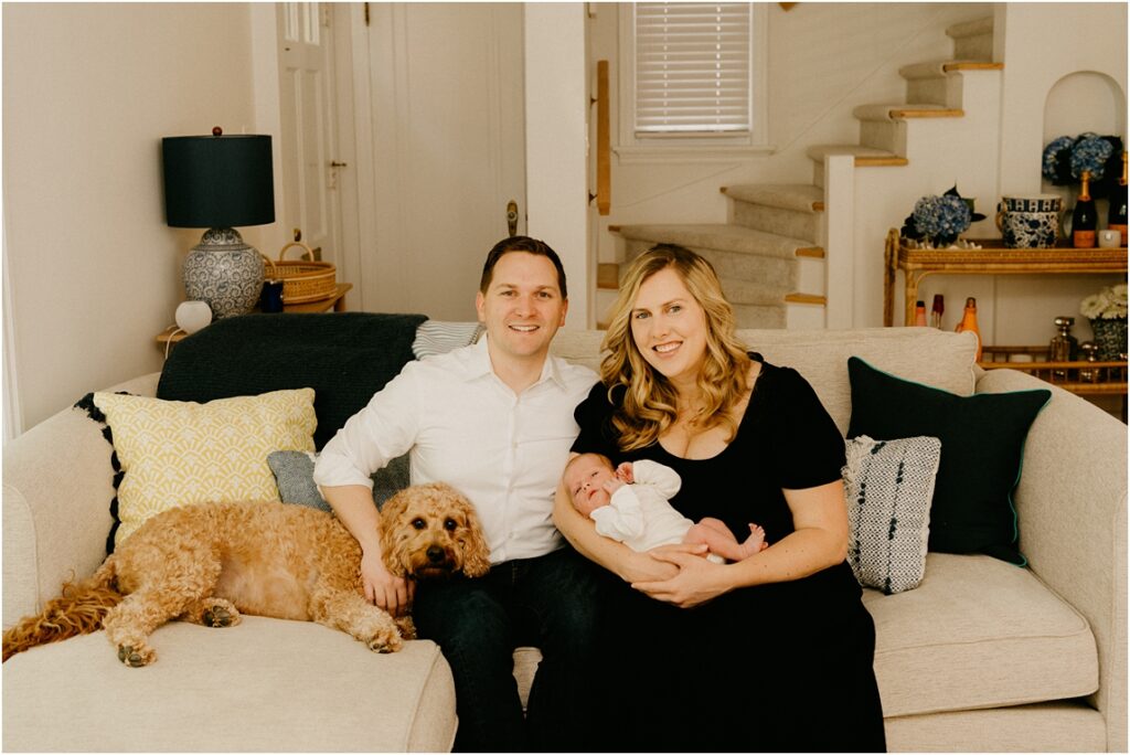newborn baby with mom and dad on couch