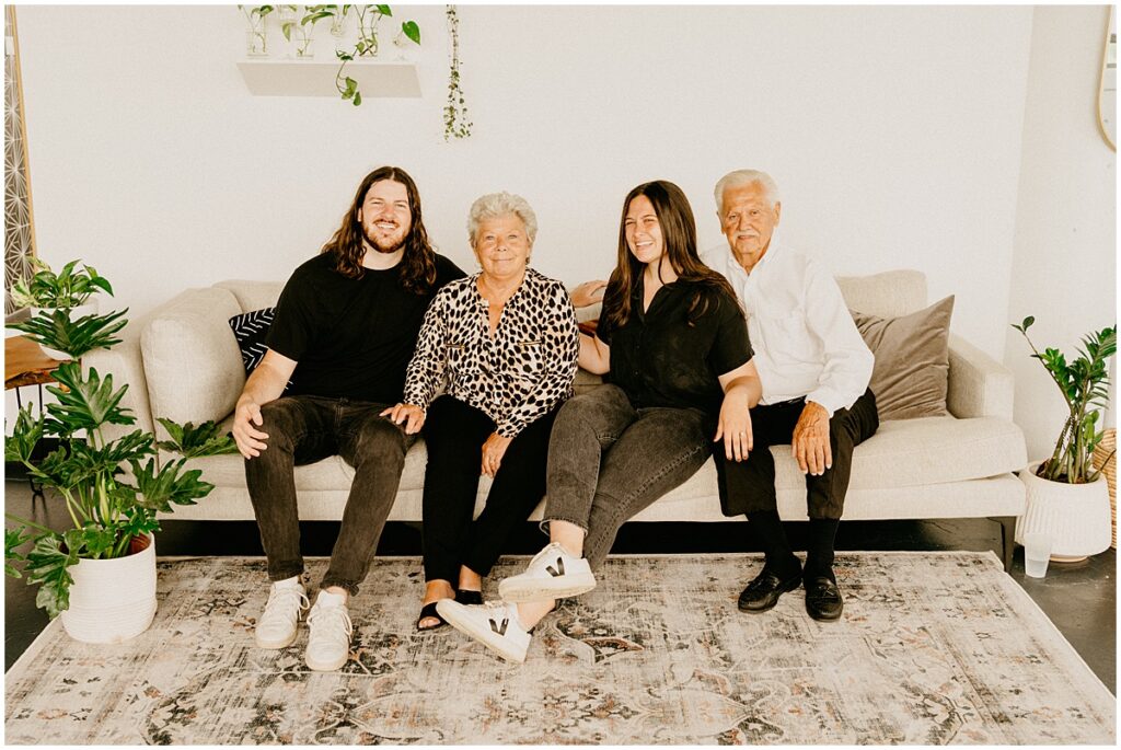 family sitting on living room couch