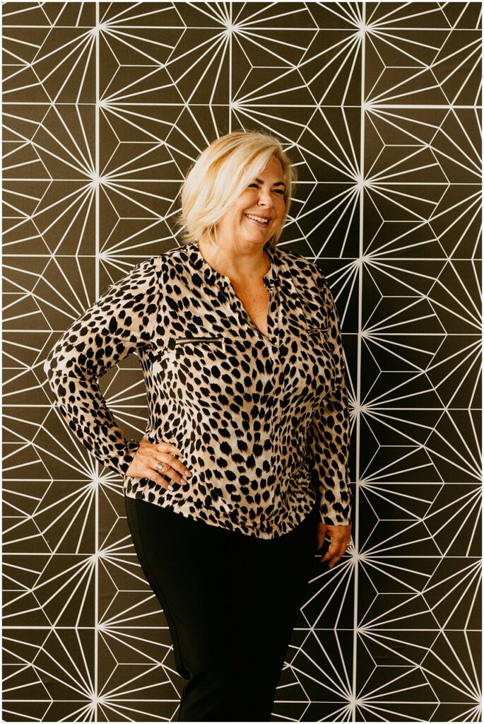 woman smiling against black and white wall