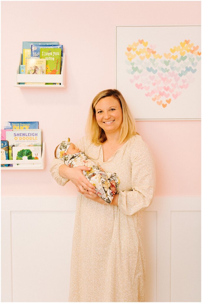 mom smiling holding baby girl