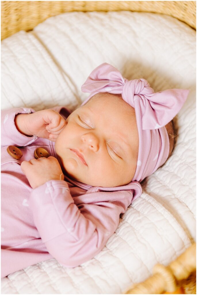 newborn baby girl wearing pink bow