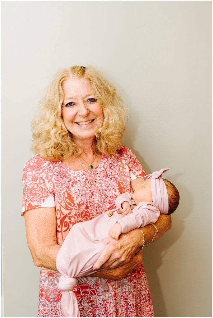grandmother holding newborn baby girl