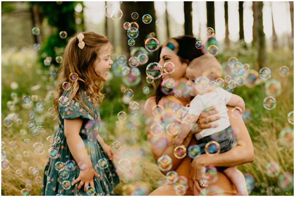 mom and kids smiling with bubbles