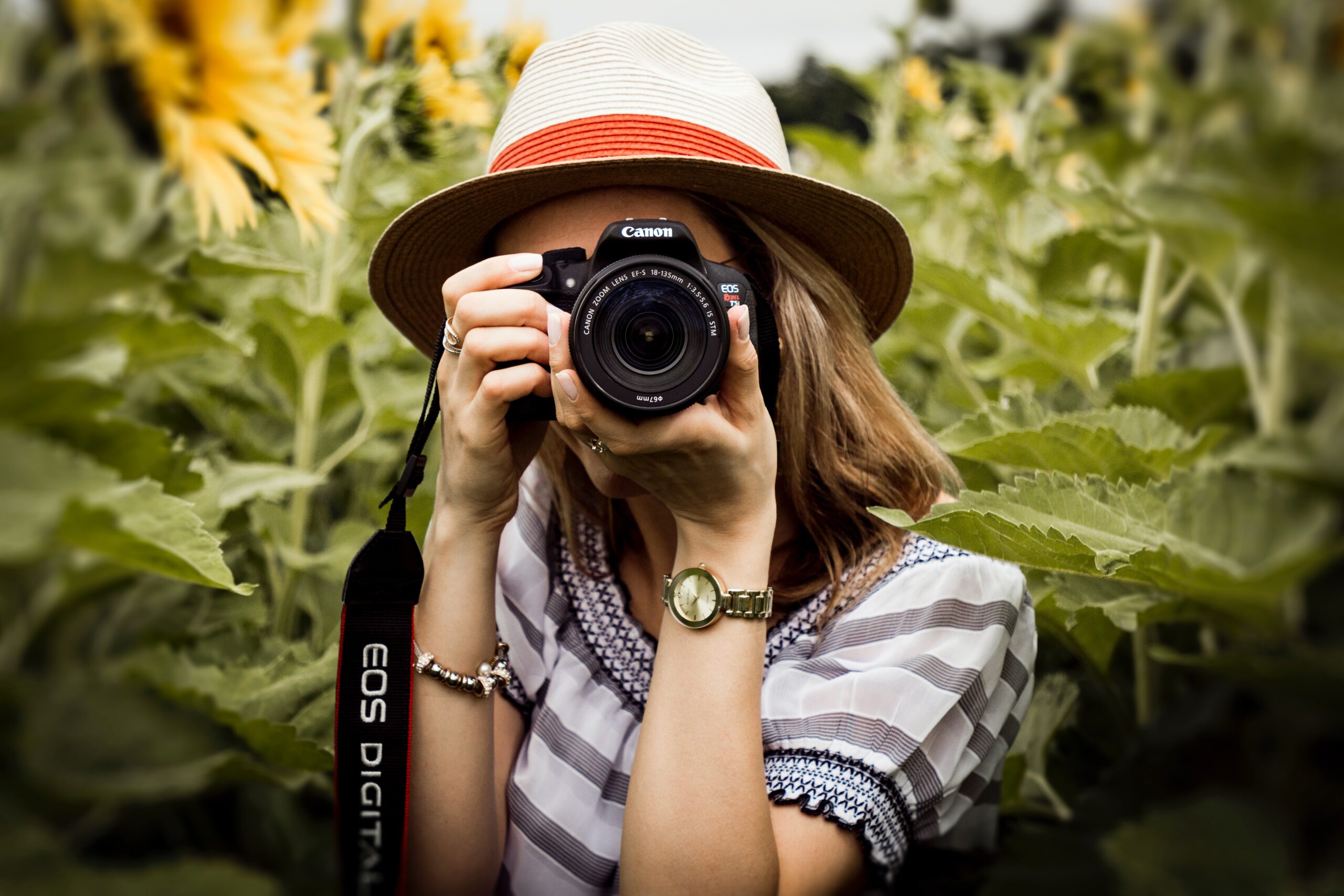 woman holding canon camera