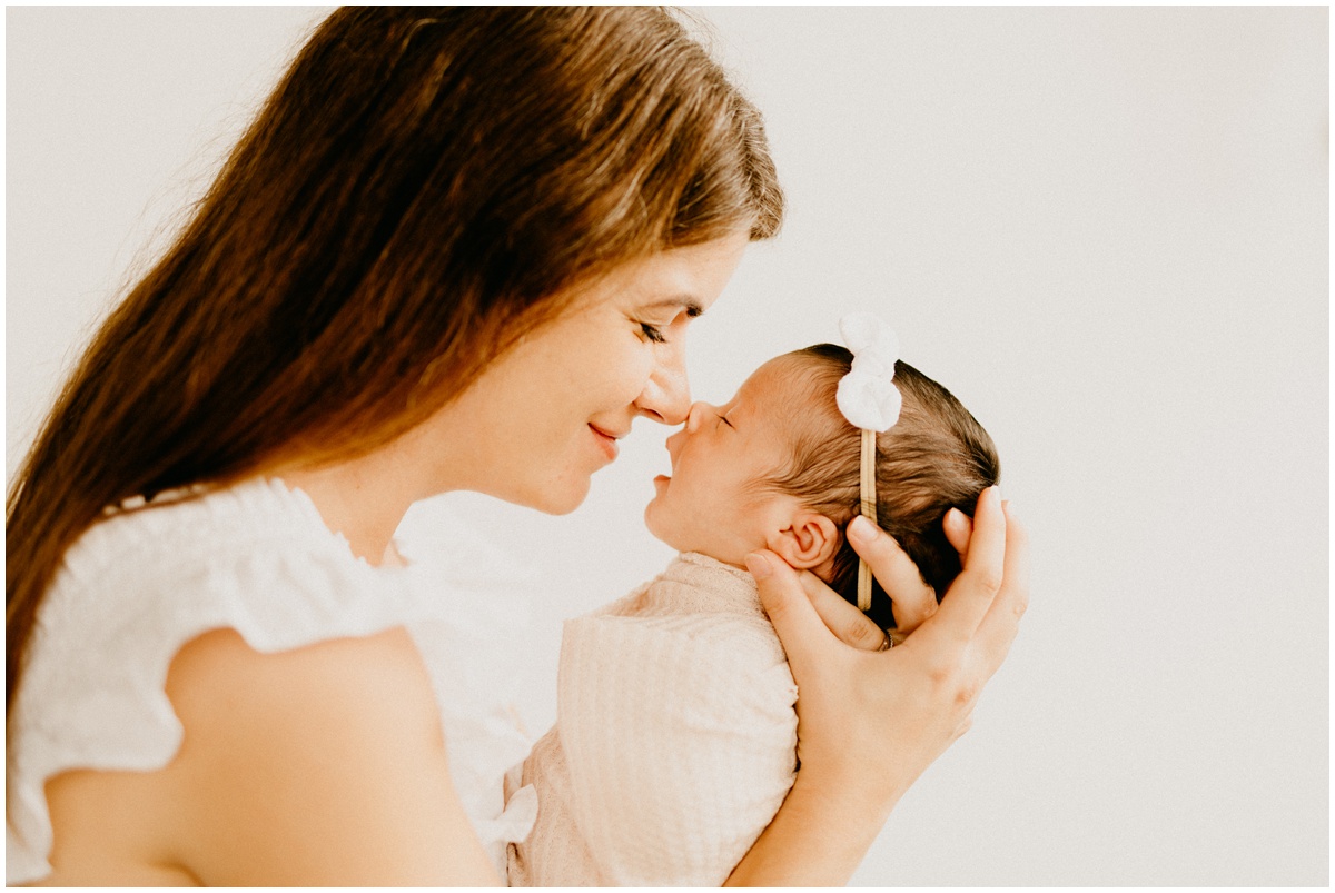 mom touching noses with infant