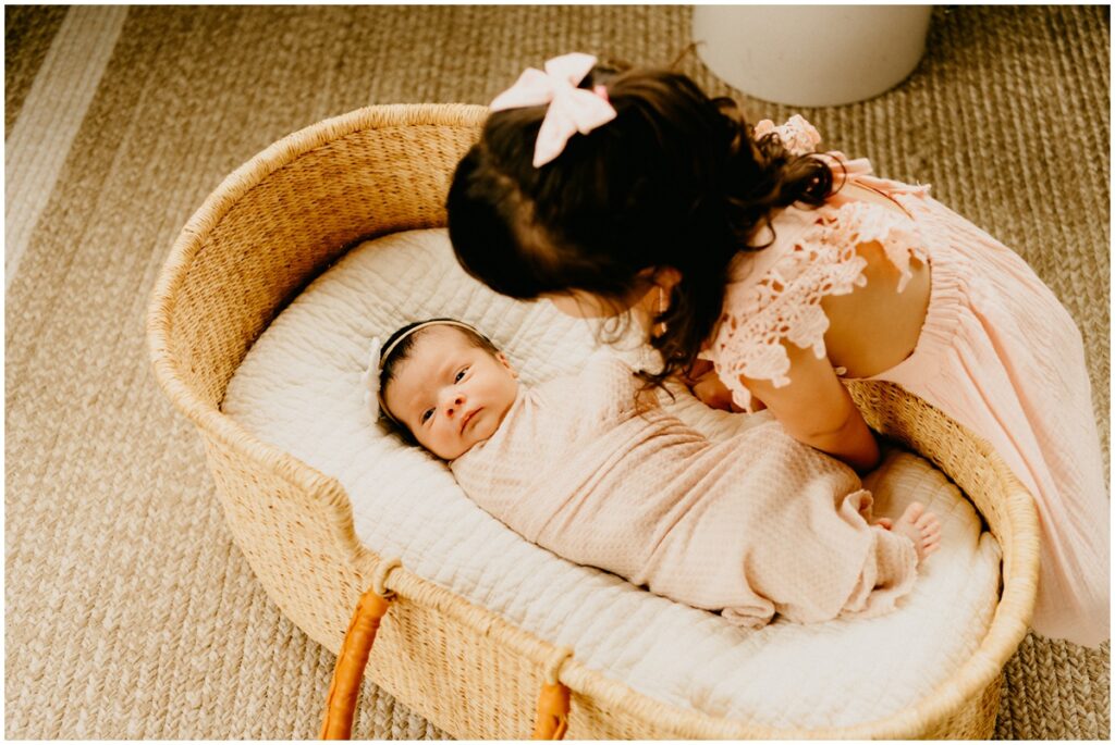sister and newborn baby girl