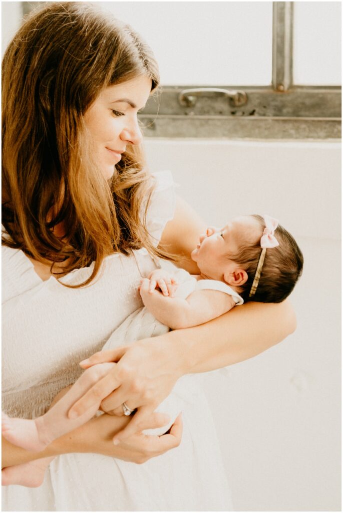 mom looking at infant baby