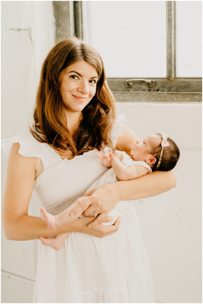 mom and baby by a window