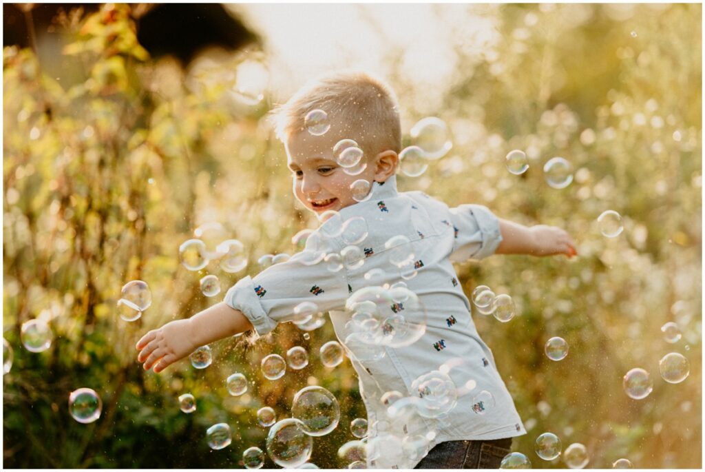 young boy playing with bubbles