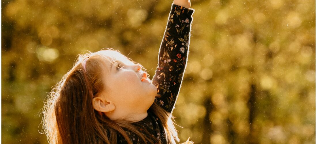 girl reaching to pop a bubble