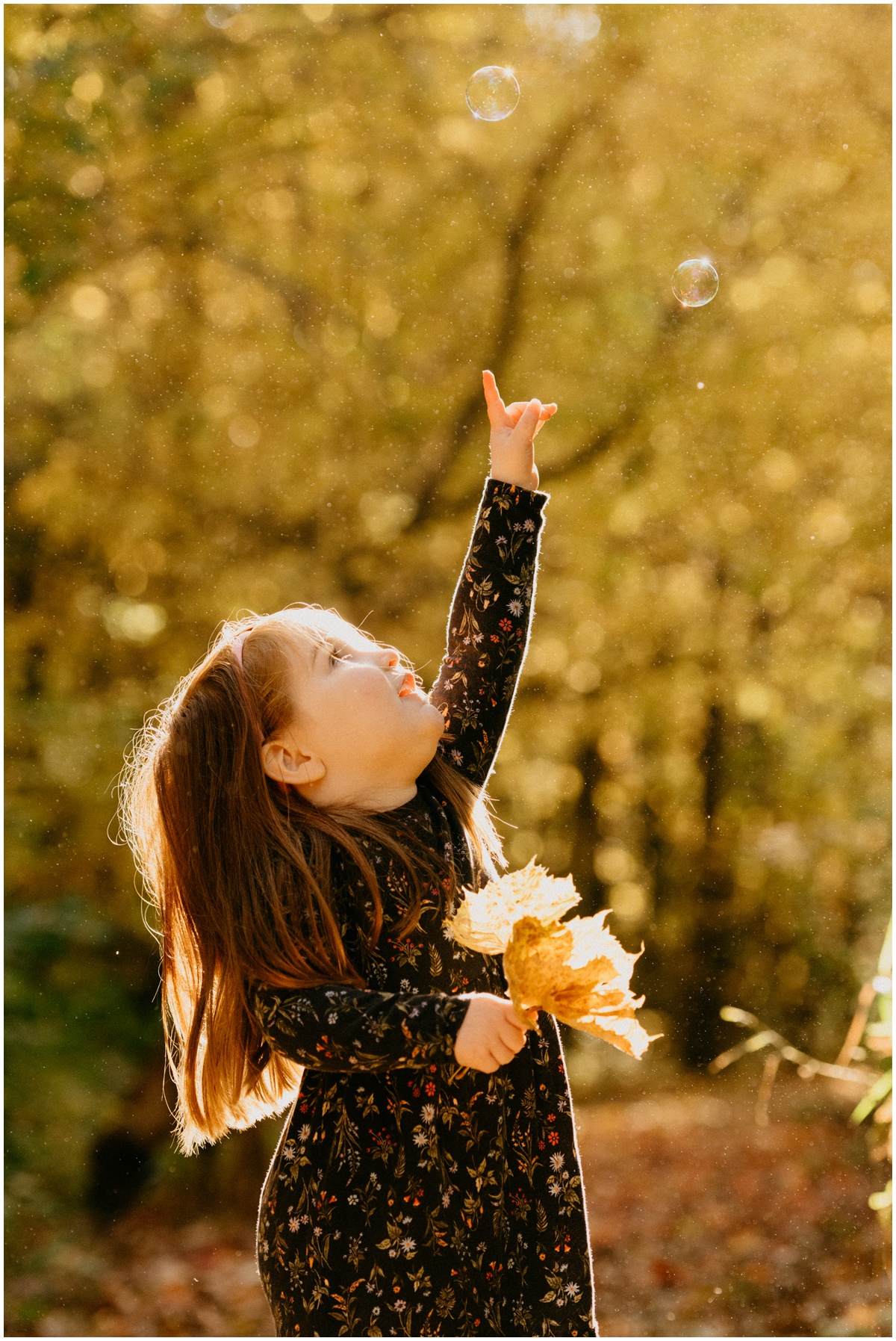 girl reaching to pop a bubble