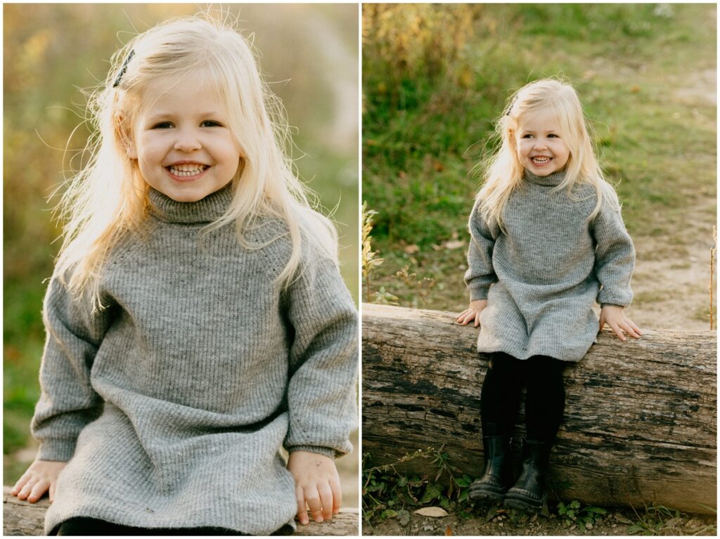 little girl smiling sitting on a tree