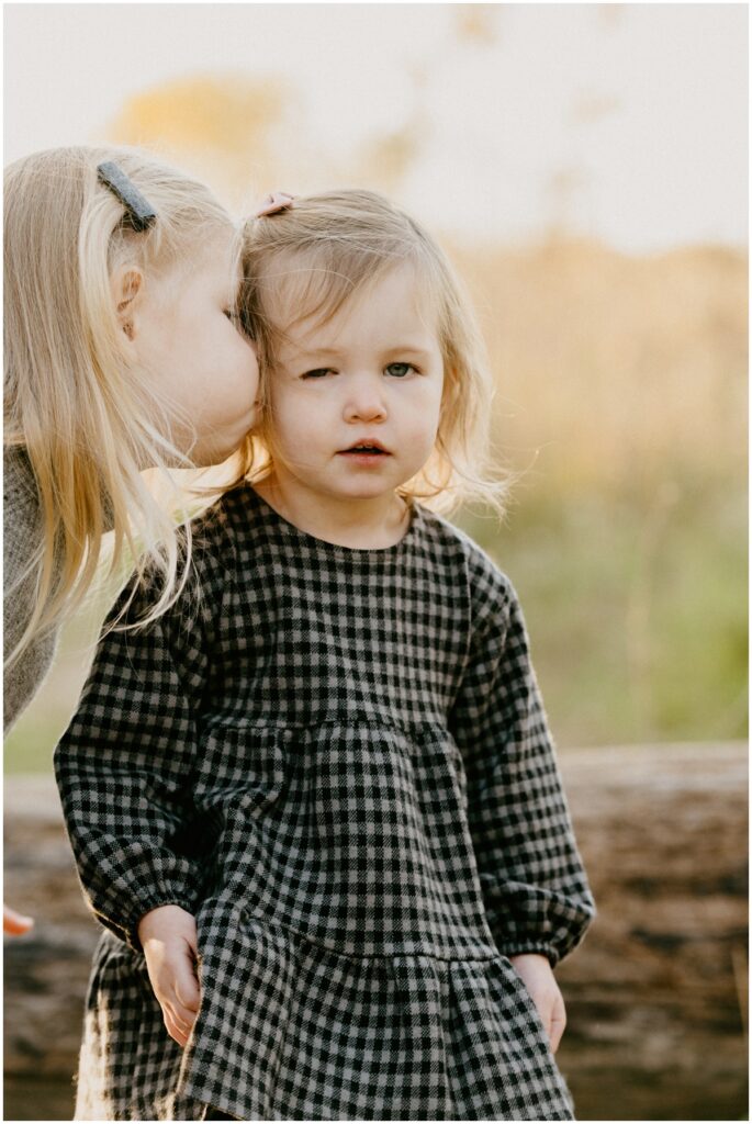 sisters kissing cheek