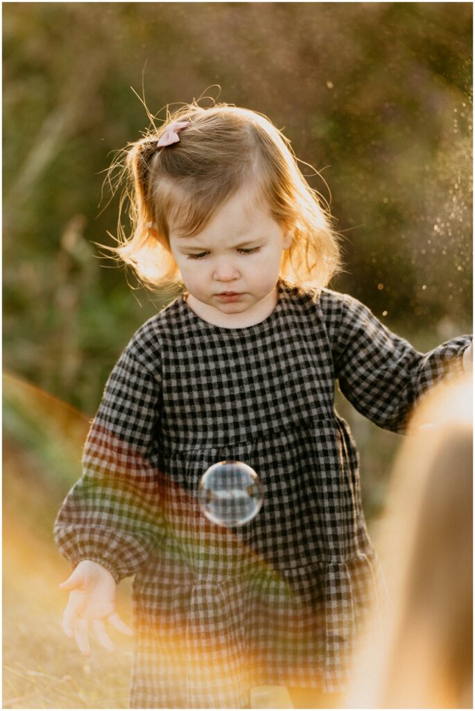 girl playing with bubbles