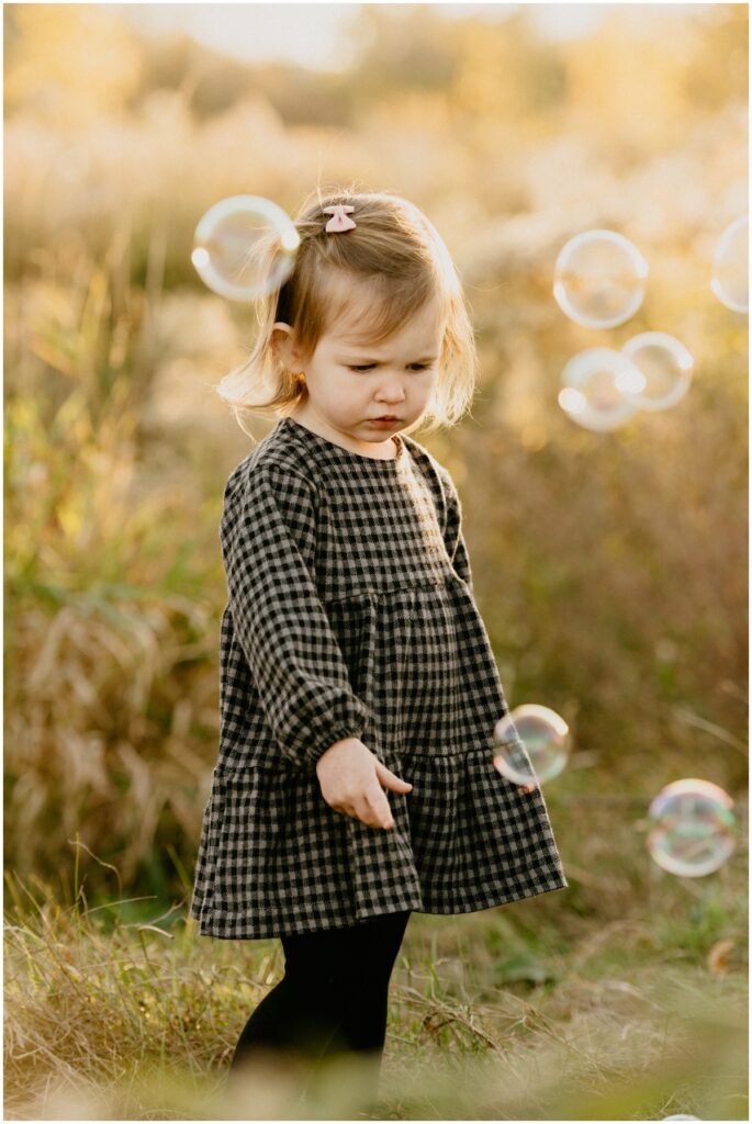 little girl playing with bubbles