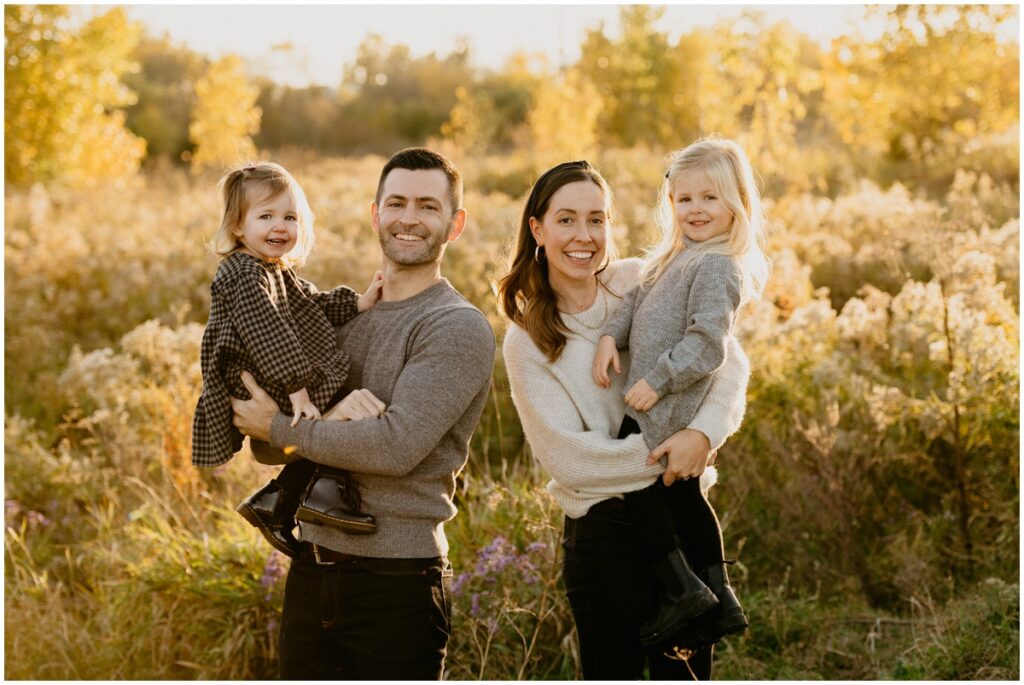 smiling family at a park in the fall