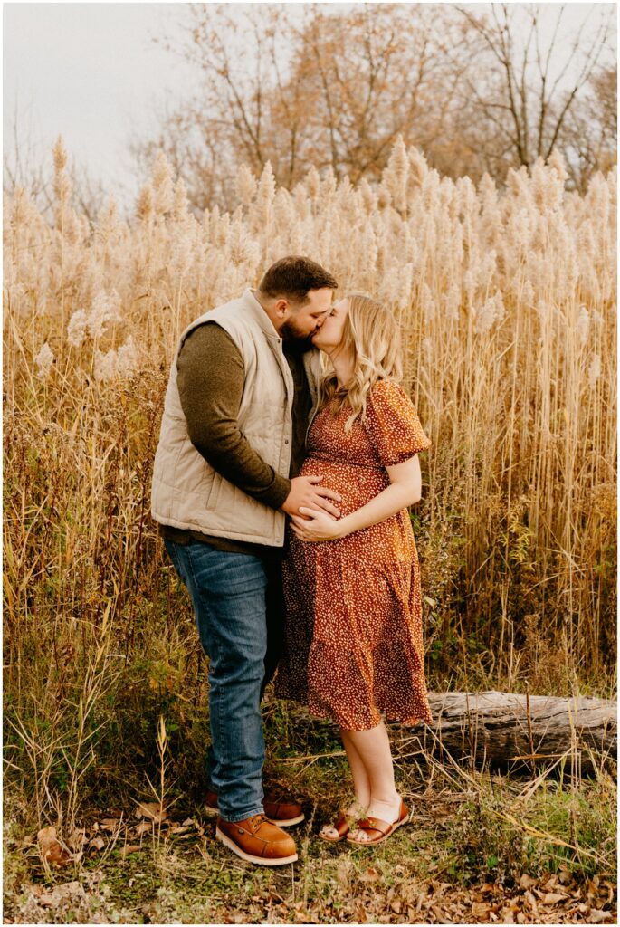 pregnant wife kissing husband