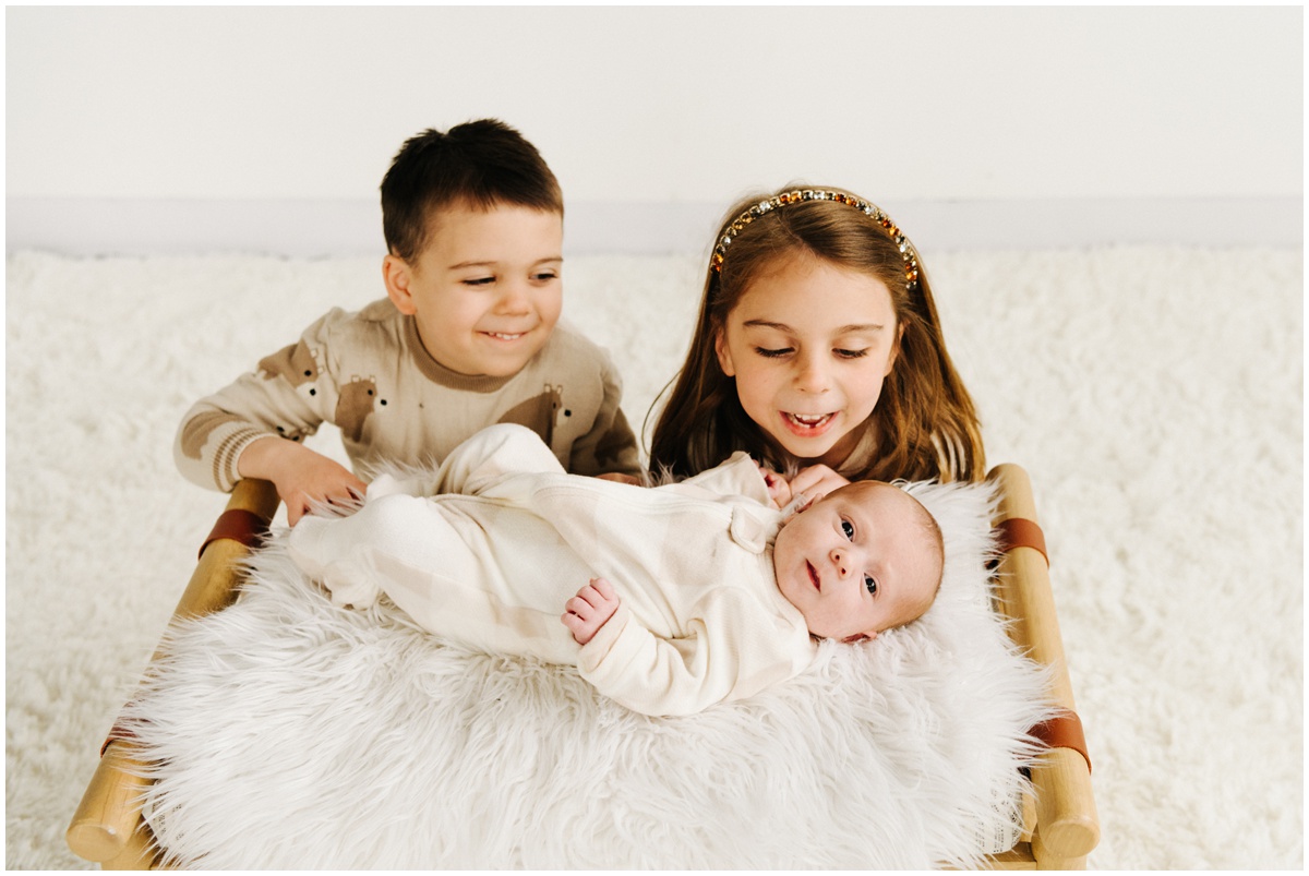 siblings with newborn baby sister