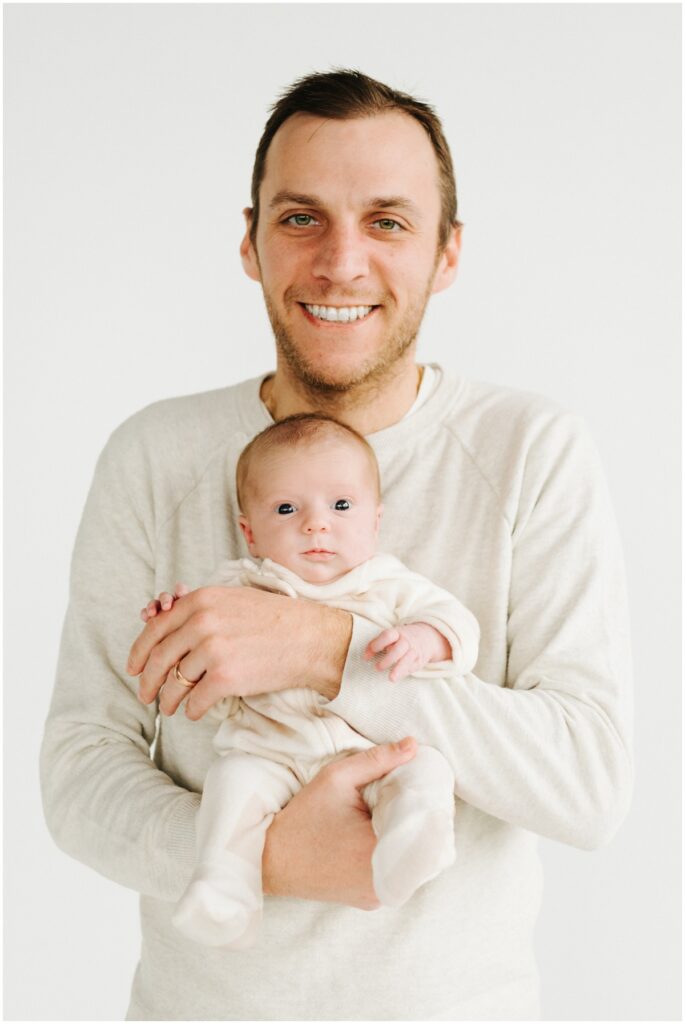 dad holding newborn baby girl