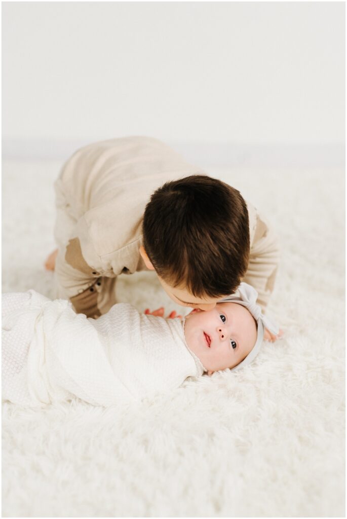 little brother kissing baby sister