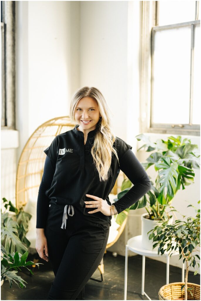 smiling blonde nurse in black scrubs