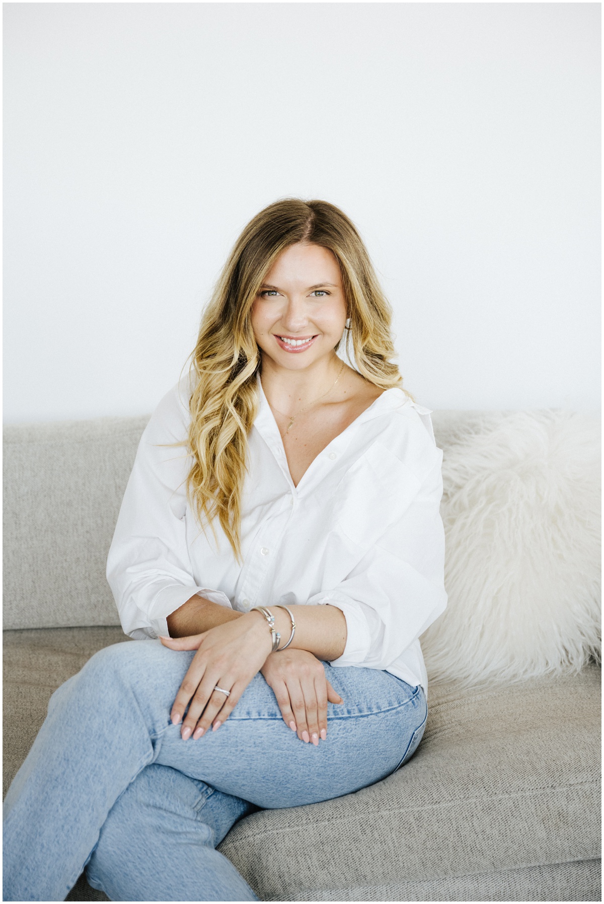 woman smiling at camera in a white blouse