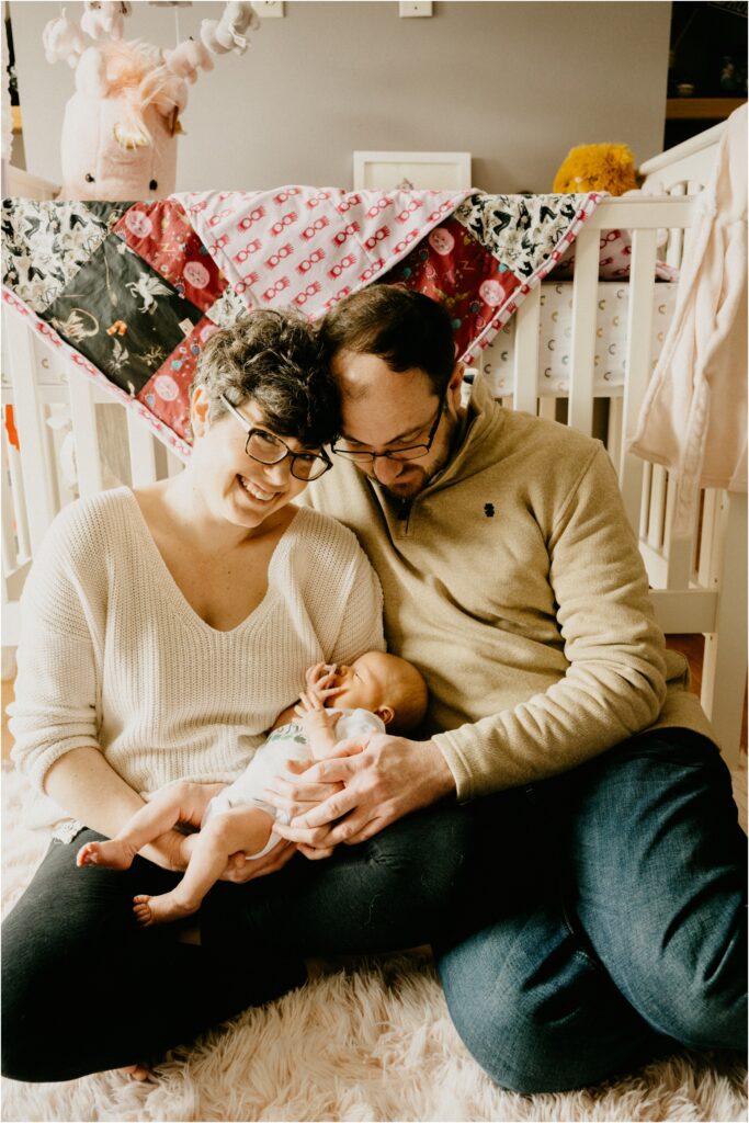 mom and dad holding baby