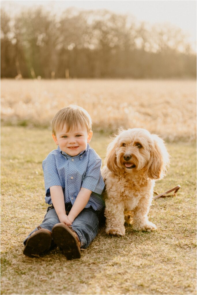 smiling boy in blue with pet dog