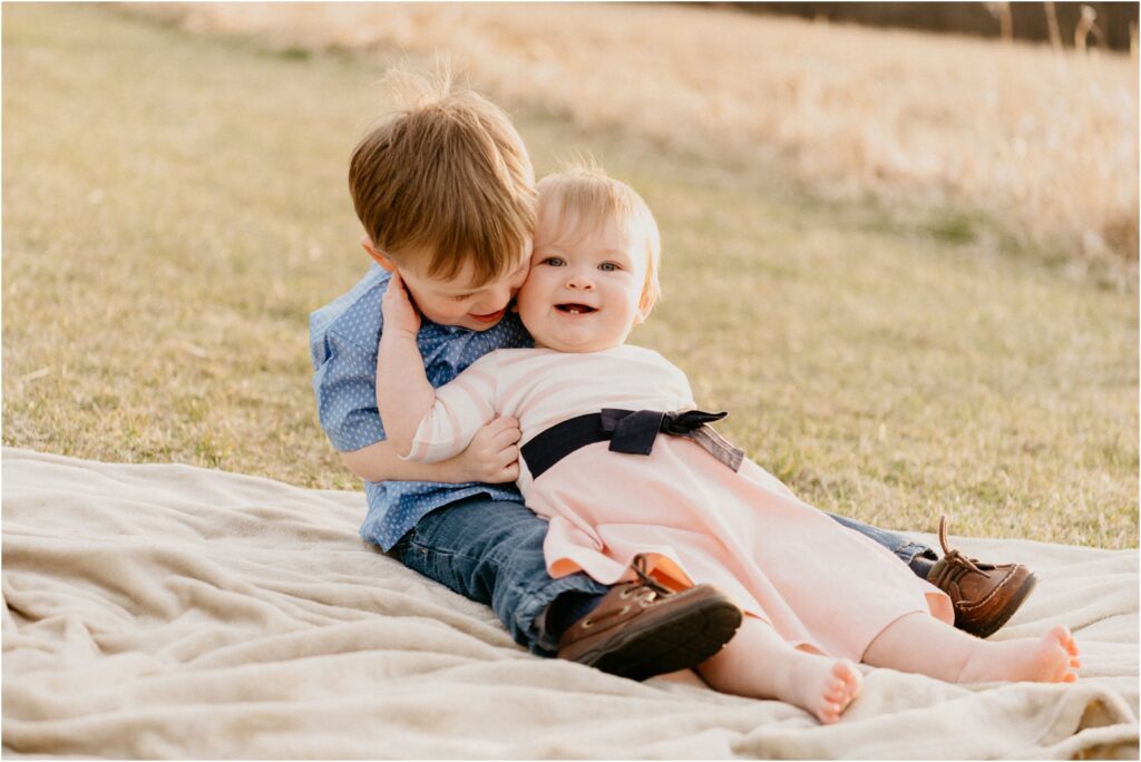 sister and brother hugging