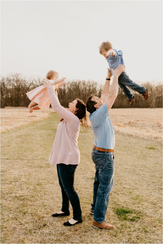 parents holding children in the air