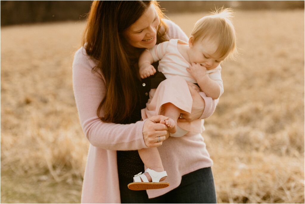 mom holding smiling daughter