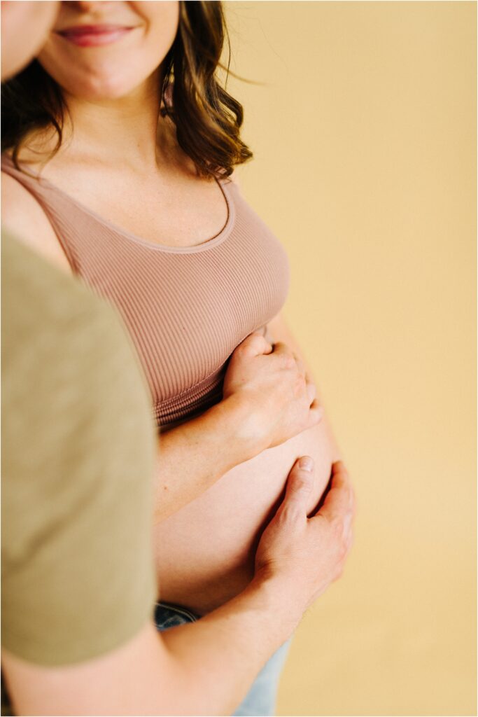 a closeup of a maternity session belly