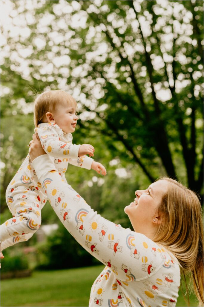 little girl being lifted up by mom