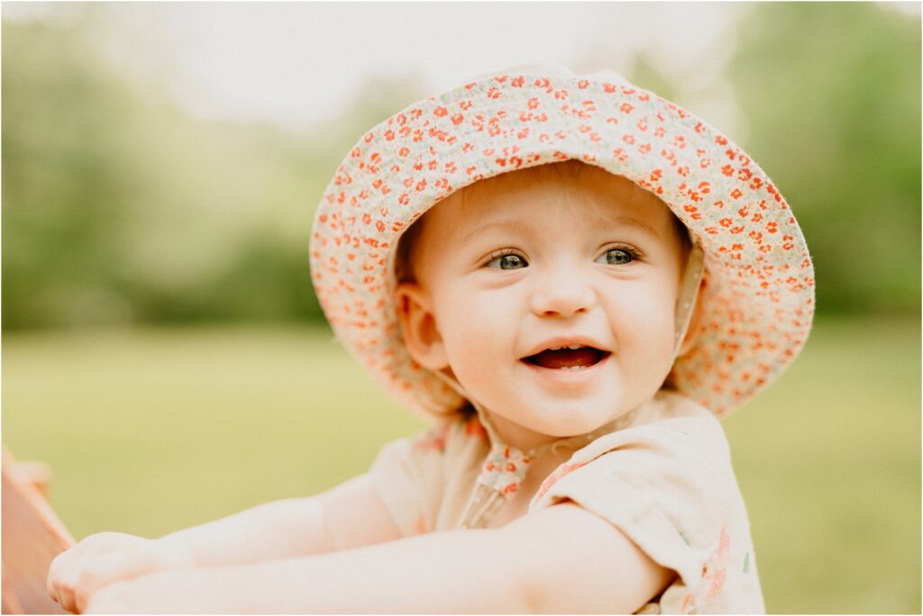 smiling little girl with a cute pink hat